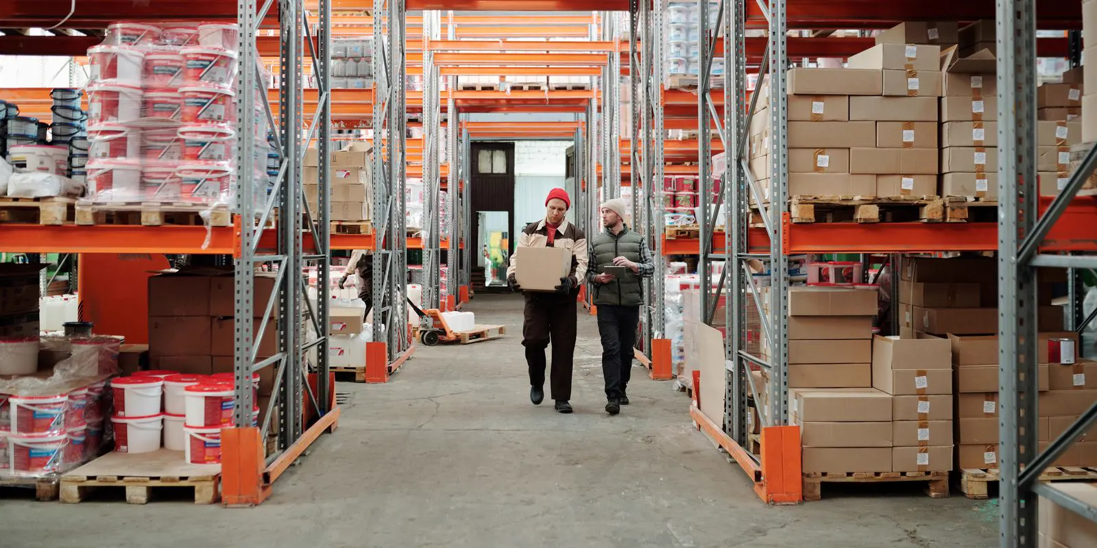 Large commercial warehouse with racking and staff